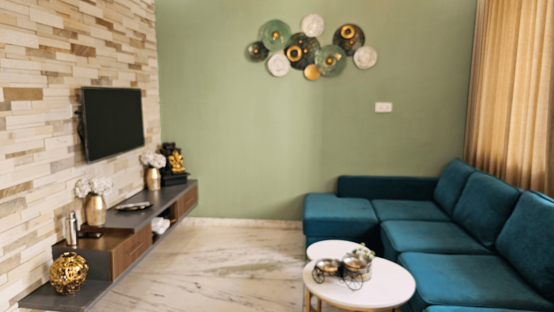 Rajeev Residence living area with sectional sofa and accent wall